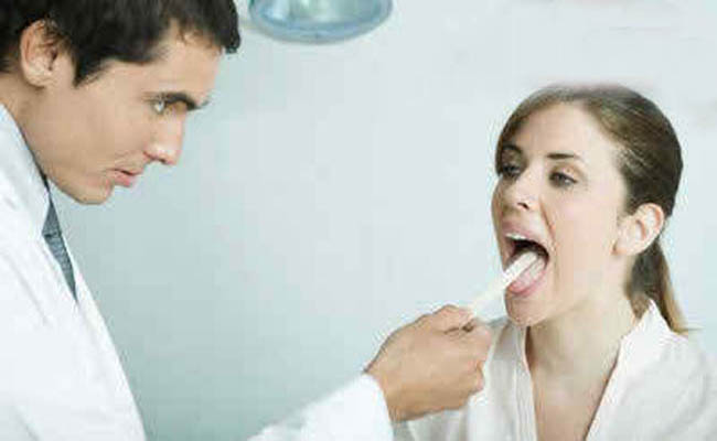 female-doctor-checking-out-tongue